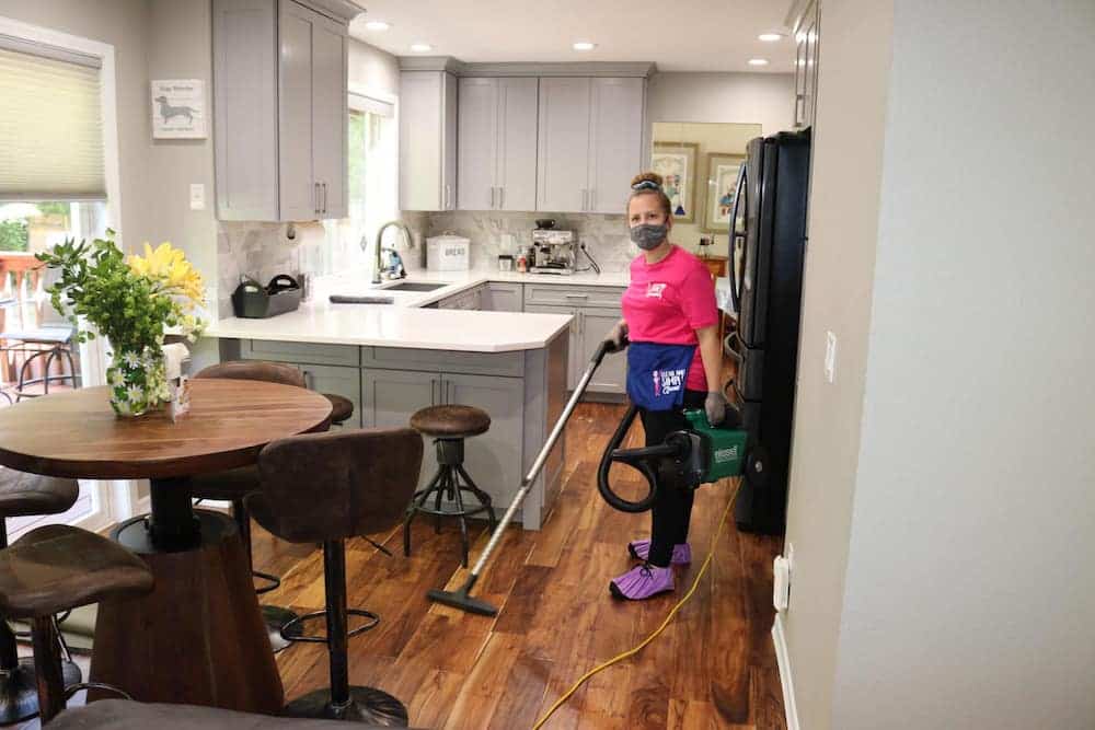 employee vacuuming the kitchen